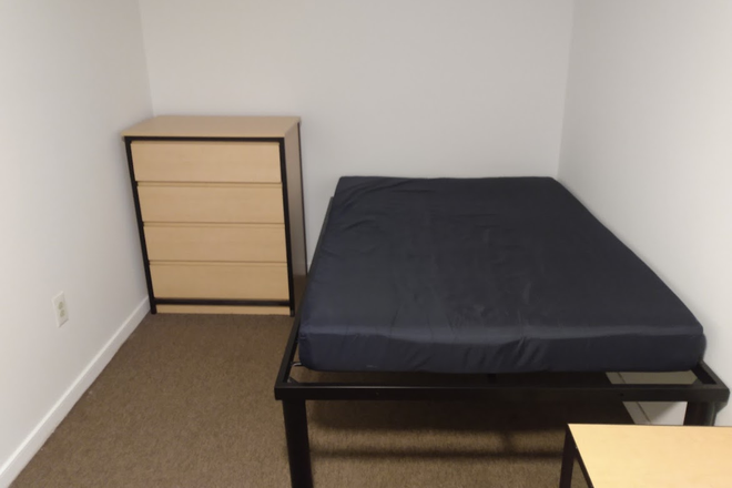 Bed and dresser - South Campus Commons Building 1, 1 bedroom available