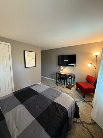 Bedroom with desk, chair and mounted TV - Furnished Private Room with Private Full Bath, All Utilities Included, Walk to UMB Townhome