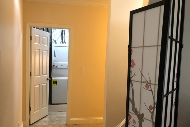 From living room to laundry/kitchenette/utility room. - 800 sq ft private space (bd, bath, living rm) + kitchenette in shared laundry rm; available 1/1/26 House