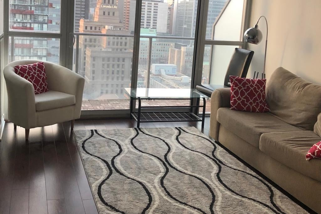 Living Room - 2 Bedroom apartment with laundry. Gym, theater, rooftop, pool included