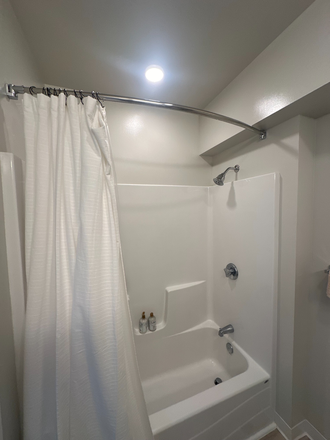 Your own shower/ tub. Shower has great water pressure! - Fieldstone Apartments