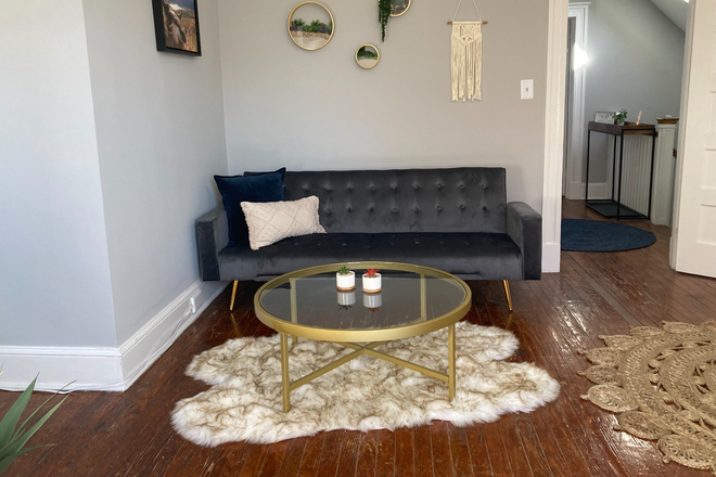 Comfy seating area in first bedroom - 2 bdrm suite w/private bath 5 min. walk to campus Townhome