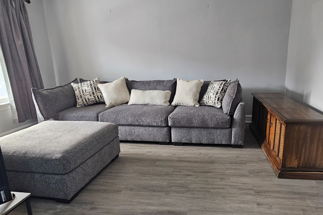 Family Room Couch - Fully Furnished 2BR Near UIC | Utilities Included | Garage Parking | Available Now Apartments