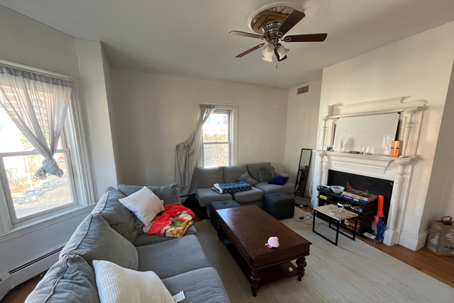 Living Room - Four bedroom with two full bathrooms, central air conditioning and will have Laundry in unit Apartments