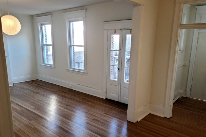 livingroom out to balcony - Newly Renovated Four Bedroom Two Full Bath Apartment