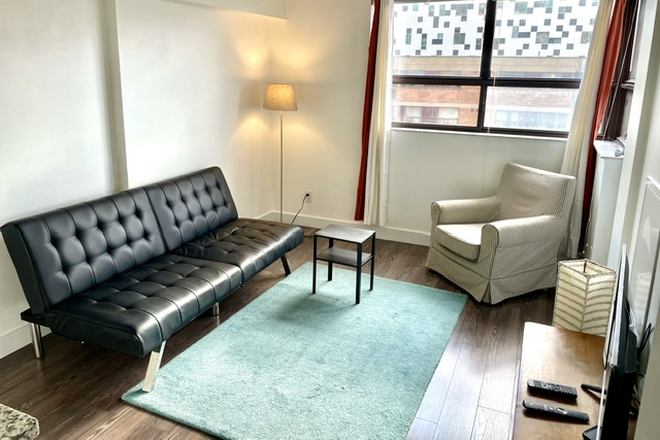 Living room - Bright 1-bedroom with balcony — Rent controlled · All utilities included · Furnished or unfurnished