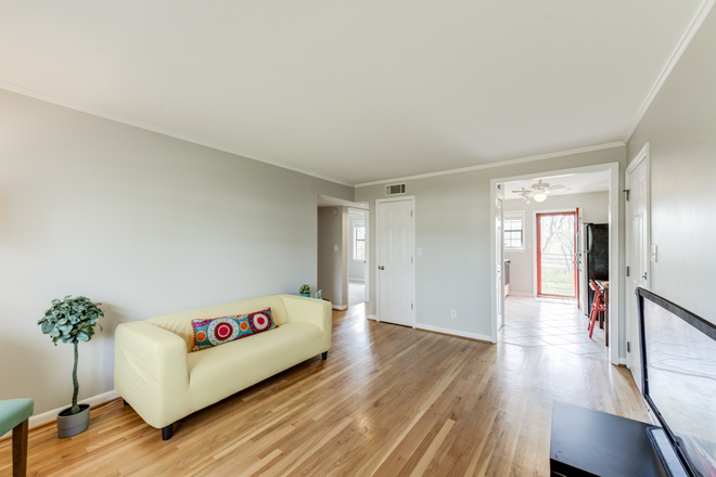 Living room w hardwoods, viewing kitchen - Quiet 2 BR / 1 Bath Condo in Candler Park -- Near Marta and An Easy Commute to Emory