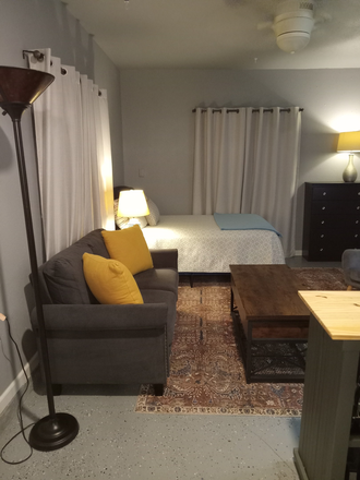 Living area and bedroom - FULLY FURNISHED, ALL UTILITIES PAID, MOVE-IN READY Apartments