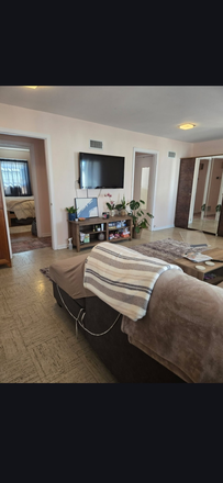 Living room - 2-Bedroom Apartment for Rent – Available July 1 1,100 sq ft, furnished living/dining room, 50-inch T