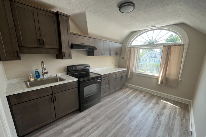 Newly renovated eat-in kitchen with large windows.  In addition to cabinets there are two storage closets with shelves. - WCP Properties Apartments