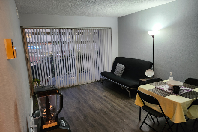 Living Room with View of Balcony - Helix at the District apartment for rent starting January 2026