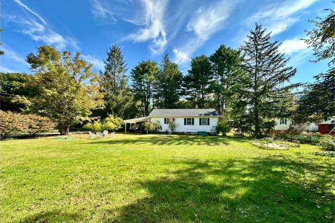 Backyard area, and house with carport - Quiet 2 bedroom ranch - minutes to campus