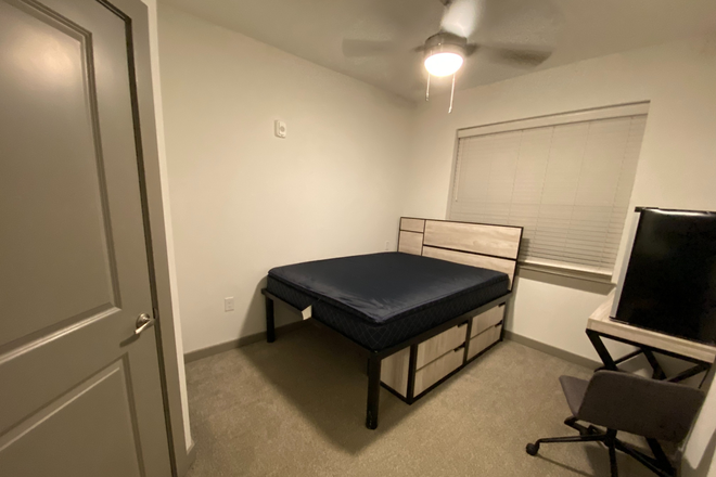 room fully furnished with drawers, desk, and chair - 14SixtyFive Apartments