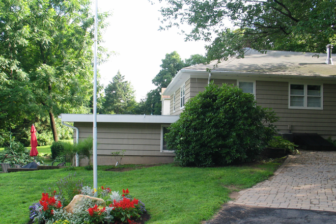 Side view of the private apartment entrance and attached home - Sunny 1-Bedroom with Living/Dining + Bonus Room Apartments