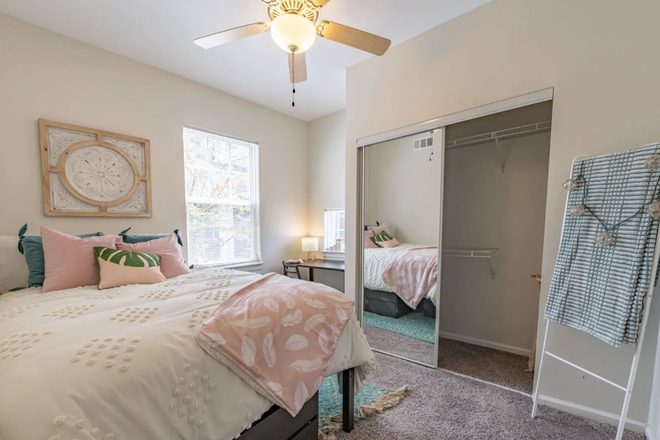 Another angle on bedroom with sliding closet, desk, and dressers. - Alight West Lafayette, close to campus, convenient lower floor unit. Apartments