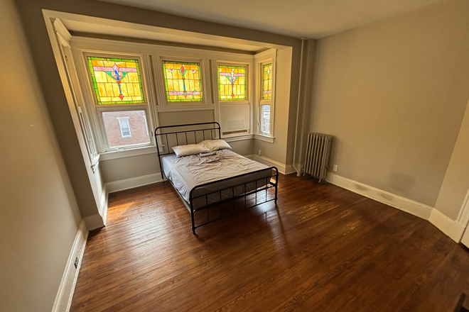 The bedroom for rent. The bed is available for the subletter - Sublet available in Charles Village Row House