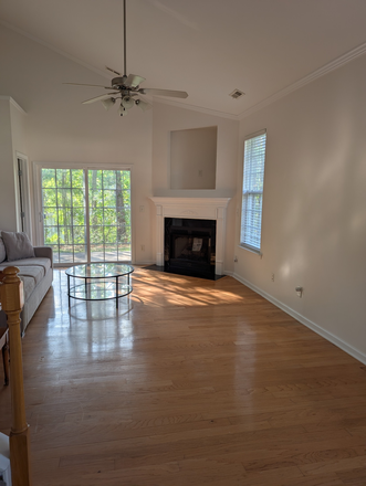 Living room with gas fireplace, vaulted ceilings and TV nook. - Refreshed townhouse in Hope Valley Farms