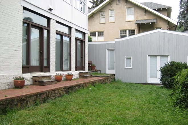 gray-stained wood exterior of detached ADU/studio cottage, North Downtown adjacent to historic home - Detached studio cottage for 1 person, 3 blocks from downtown mall Rental