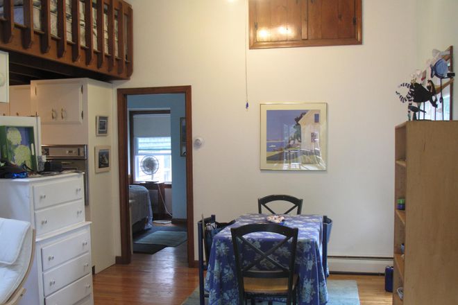 Dining room, loft, entrance to the kitchen under the loft, & door to the bedroom - Sunny, Furnished Westport Apartment (Rent Includes Utilities)