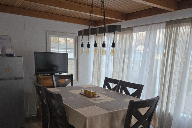 a beautiful and comfortable dining room with good lighting and a view of the patio - Jorge Cajas House