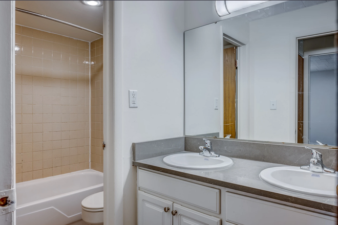 Bathroom (Shower has been updated in the listed unit, this picture is from Cedar Village's website) - Cedar Village Apartments