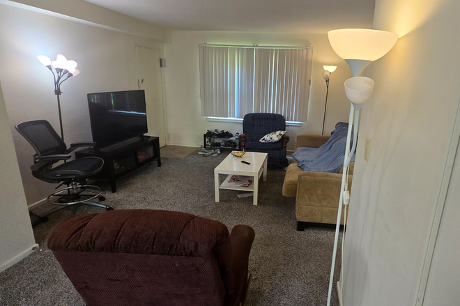 Living Room - A room for a full year lease at Graduate Gardens Apartments