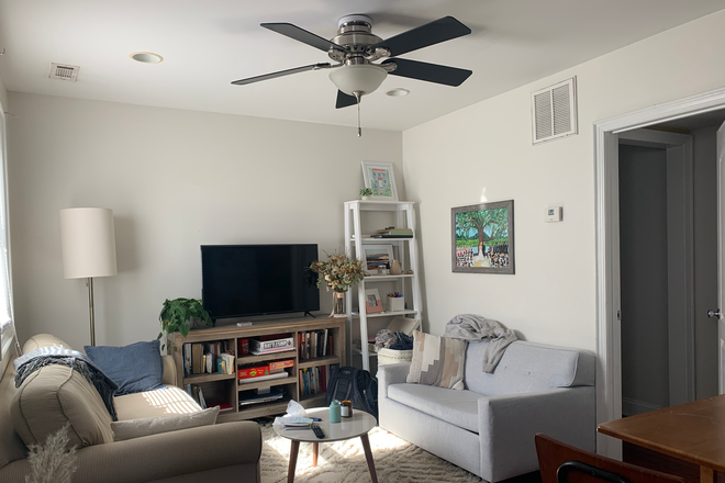 Cozy living room with natural light, ceiling fan, 1/2 bath, kitchen - Charming 1 Bed/1.5 baths, close to MUSC Apartments