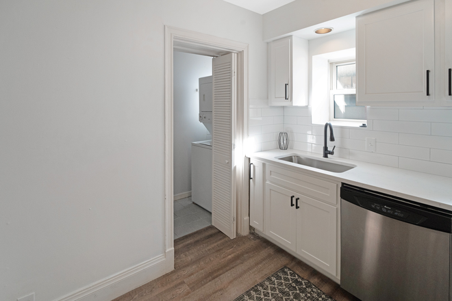 Washer and dryer off the kitchen in unit - The Tudor - large 4 bedroom Apartments