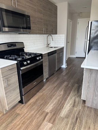 Kitchen. Dishwasher, oven, and microwave - The Ave Apartments