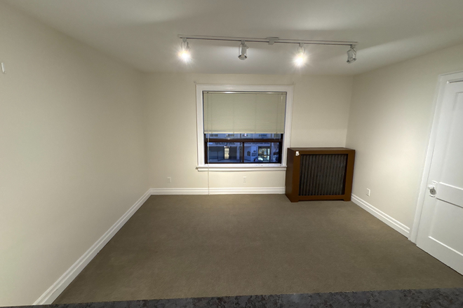 Standing in Kitchen - Looking Over Breakfast Bar - Bloor St Large Renovated Bachelor Apt.