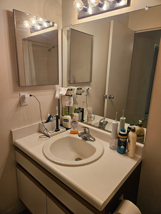 Bathroom (1/2). Medicine cabinet behind small mirror. - 2026 1BR Lease Takeover at Arbor Landings Apartments