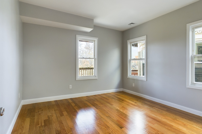 Bedroom - Modern 4BR/2BA: Central Air + In-Unit Laundry + Private Deck Apartments