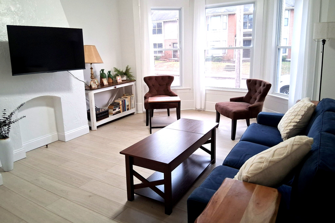 Living room with staged furniture - Huge, sunny, renovated 2BR with laundry and garage Apartments