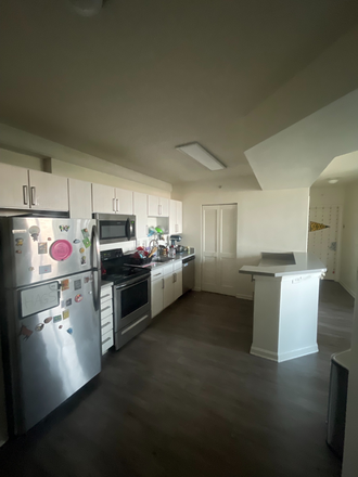 Spacious shared kitchen with stainless steel appliances, ample cabinet storage, and a large island. - University View Sublease – Private Bedroom & Bathroom Near UMD (Available August) Apartments