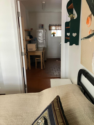 Room 1-1st floor, bedroom looking into the kitchen area - Location/convenient, private rooms available, includes all utilities, free laundry ,and WIFI Apartments