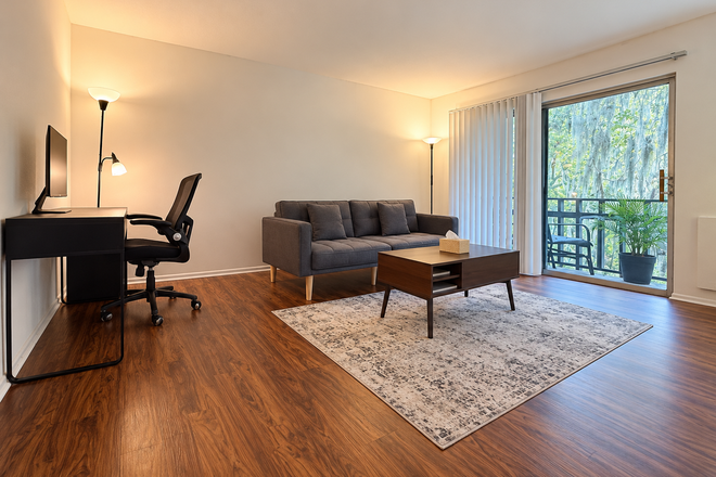 Living room - Sun Bay Apartment 1b1b – Near UF & Shands | Free Parking & Internet | Lake view balcony