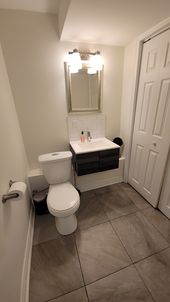 Powder room with Laundry facilities on same level - Bright and welcoming, renovated furnished basement apartment, in the Upper Beaches/Leslieville area