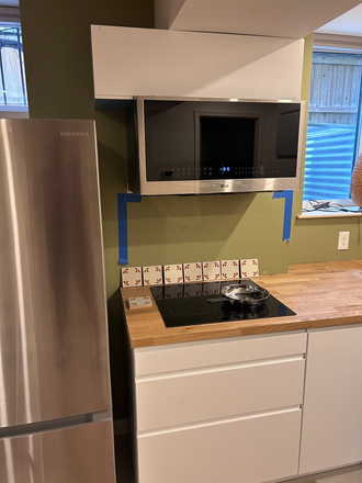 Kitchen with induction cooktop and combination microwave/convection oven - Spacious newly renovated furnished basement apartment close to Tenleytown