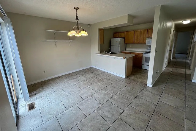 Dining room + kitchen - Apartment across the street from East Campus (Looking for two roomates)