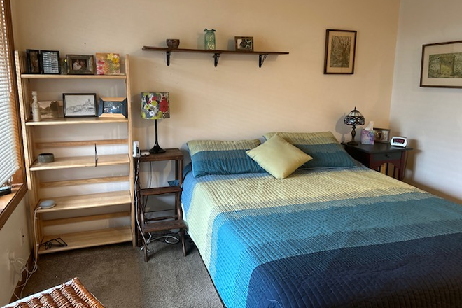 View of Bedroom with window to the left & bookcase - Quiet Room with Queen Bed, Private Bath, Kitchen & Living room use, close to bus & stores. Townhome