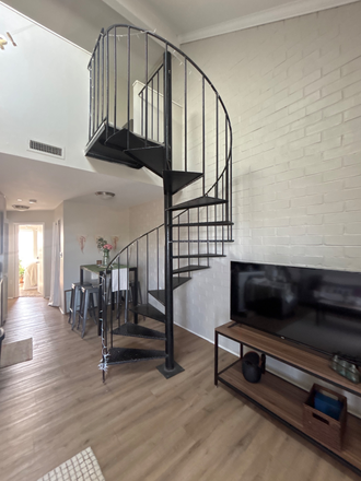 Table and stairs - Highland Grand Apartments