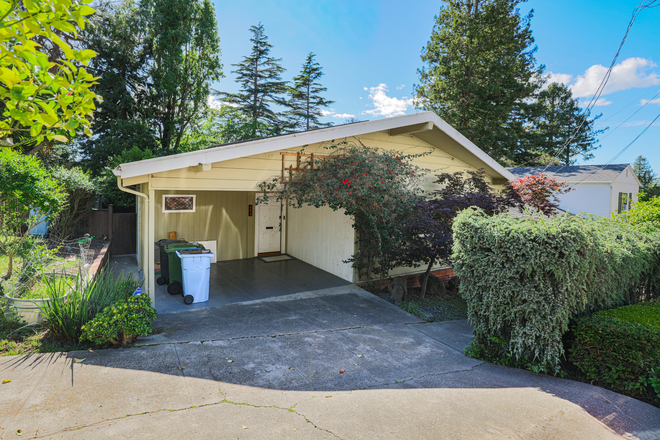 Front exterior with carport and mature landscaping — North Berkeley mid-century home. - Creekside North Berkeley 4BR + Studio | Furnished Fall 2026 Sabbatical