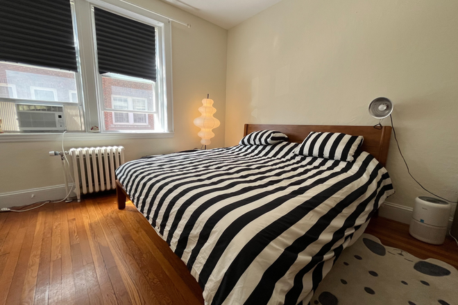 Bedroom with a king bed. - Lovely One-Bedroom Apartment Near Harvard Law