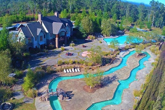 An aerial view of some of the beautiful green space, the clubhouse, pool, and the Lazy River at The View at The Pier. - $700 ALL-INCLUSIVE | 1721 sf • Privately Keyed 4x4 Luxury Condo | TWO MONTHS FREE + $1000 GIFT CARD