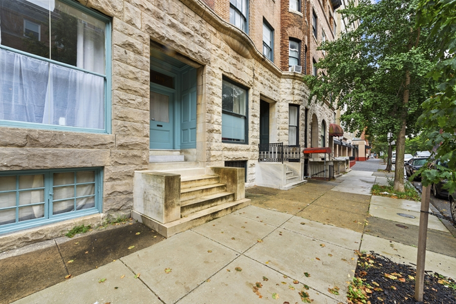 Angled view of block looking south on Calvert. - Awesome 4-5 BR home close to JHU UB MICA Loyola. Walk 2 coffee, movies, restaurants w/ yard, parking
