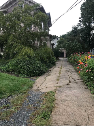 Flower filled driveway leading to entrance and garage for one vehicle. - 2 bedrm aptmt w/ garage in historic house; very large veggie, fruit and flower garden