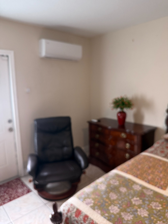 Cozy sitting area with leather recliner, dresser, private entrance and independent mini-split air conditioning. - Furnished Private Studio Near FIU – Private Entrance, Bathroom and Parking House