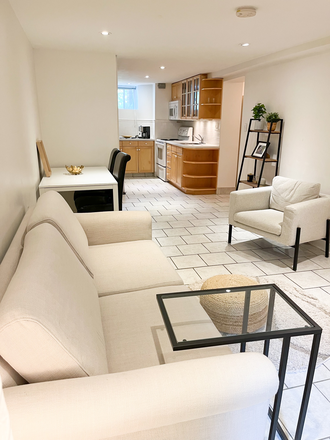 Living room and open concept kitchen - Downtown Location! Bright 2-bedroom basement apt fully furnished all included at St. Clair & Oakwood