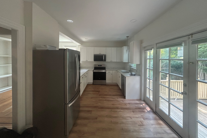 Separate living room is on other side of half-wall to left of kitchen. - Spacious, Sunlit, Renovated 3-4 Bedroom with Cute Shared Yard Triplex