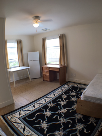 Main room with very large windows let in loads of light - Studio,  Furnished,  Quiet with Garden Near Campus, Internet, free Laundry on site.